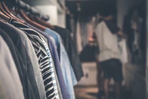 Close-up of clothes in a closet before sorting