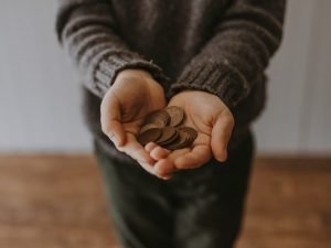 person holding coins in hands