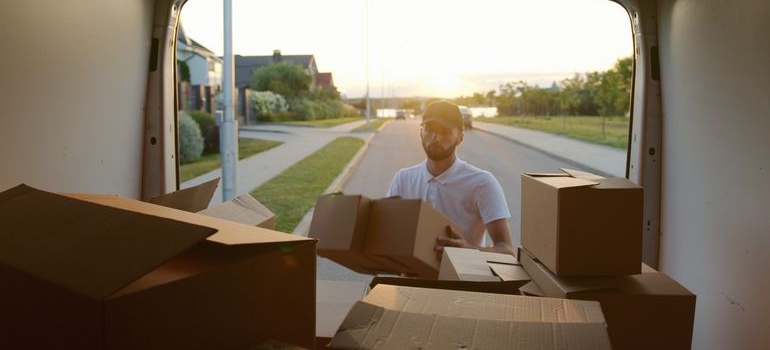 A man loading moving boxes into a truck before moving from Olive Branch to Oxford MS