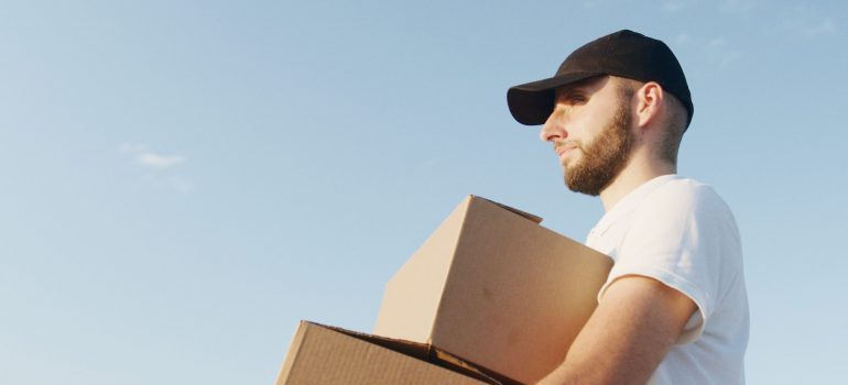 a man carrying boxes moving from Memphis to Nashville