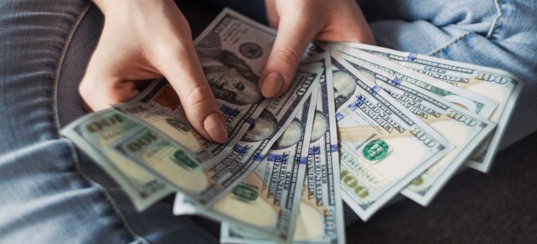Someone holding money since using your basement as storage is a good way to save money 