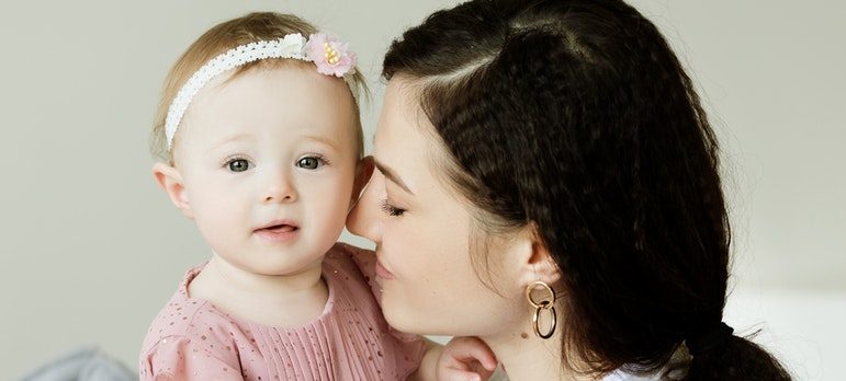 A woman kissing her child during a move