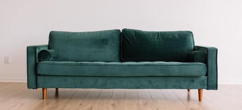 A green upholstered couch