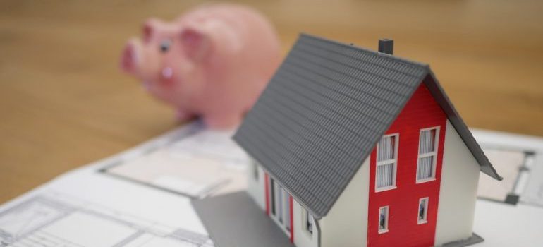 A model of a house and a pig as a symbol of costs