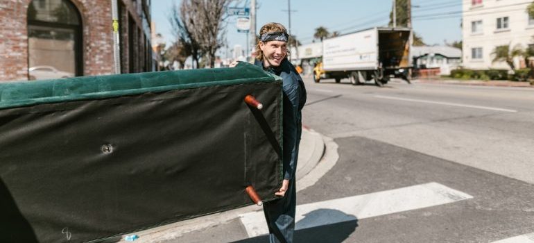 Professional mover carrying a piece of furniture
