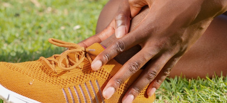 person holding sprained ankle