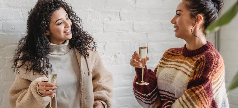 Two women drinking wine together, a relaxed way of befriending neighbors