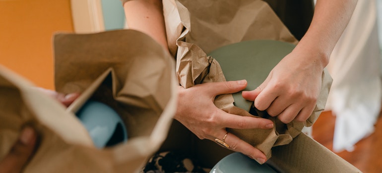 Two people packing their belongings for the move