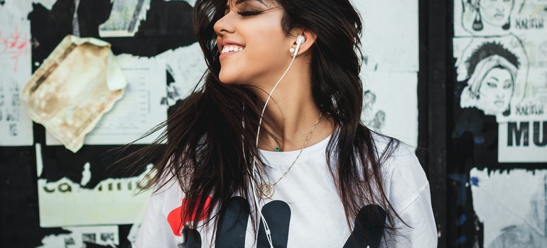 Young woman with headphones listening to music outdoors