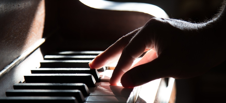 Piano time, fingers over piano keyboard.