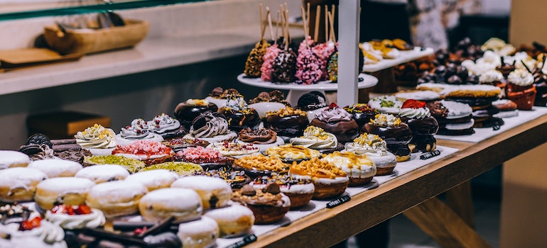 Donuts and bagels on display in a bakery case
