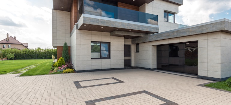 Modern house with a large garage door and a paved driveway