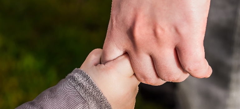 Dad and the kid holding hands