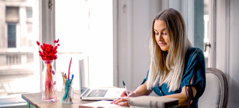 A woman researching her new city on a laptop to overcome the fear of moving house