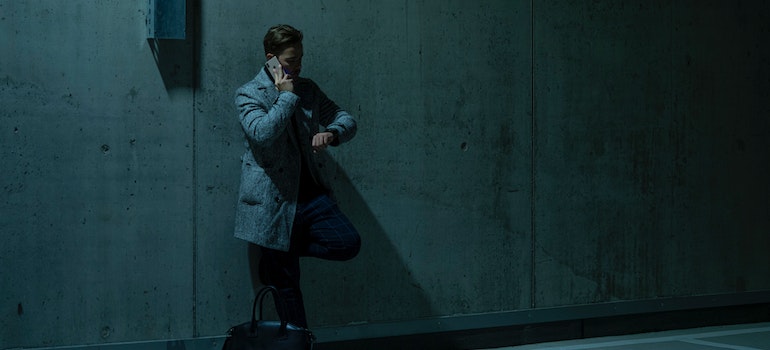 A man checking his wristwatch while waiting