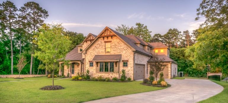 A two-story house with a green front lawn