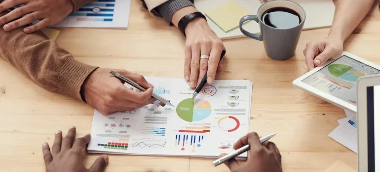 Startup team reviewing graphs and charts at a meeting table