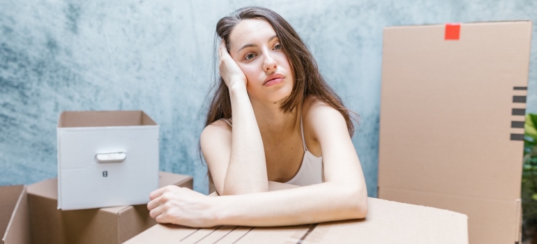 A woman thinking about common mistakes to avoid when moving to a new state