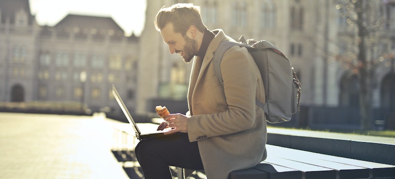 A person using a laptop in a park, a common sight in the best CO cities for digital nomads