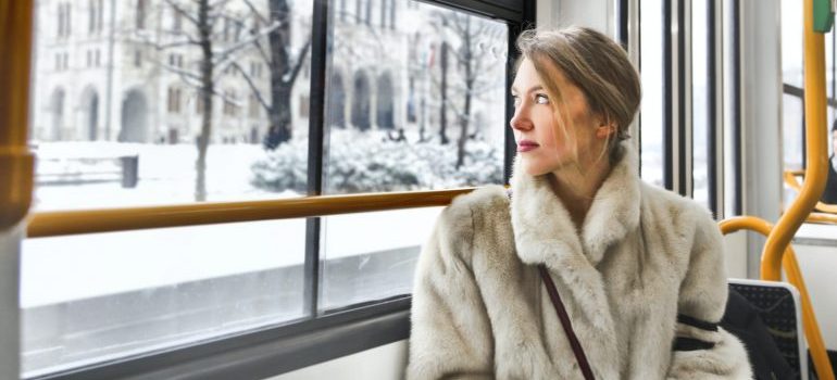 A young woman riding a city bus, one of the reasons people are leaving Memphis is limited public transit