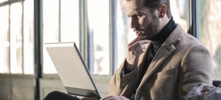 A person at a laptop thinking about the appeal of moving from Germantown to Bartlett