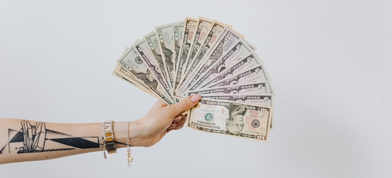 a person holding dollar bills