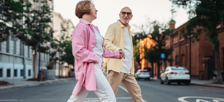 Older man and woman walking together along a park path