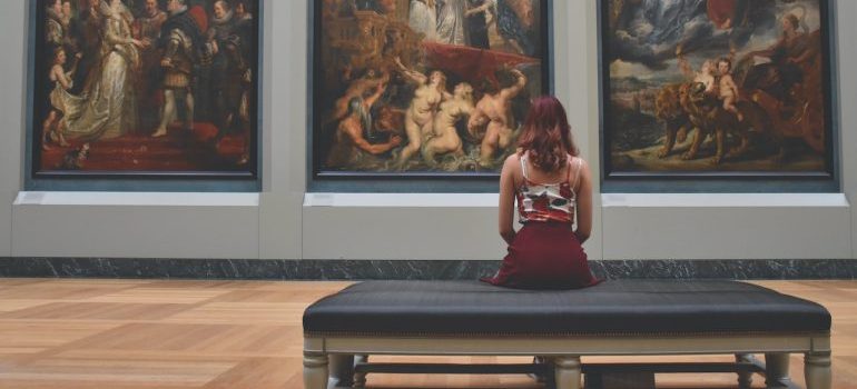 woman sitting in a museum