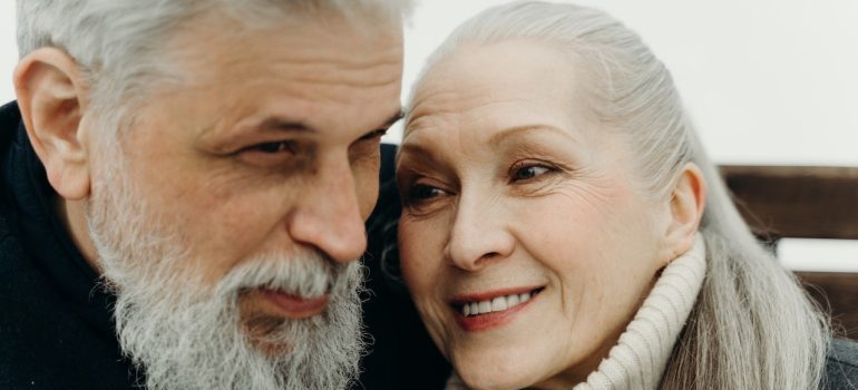 An elderly couple laughing together