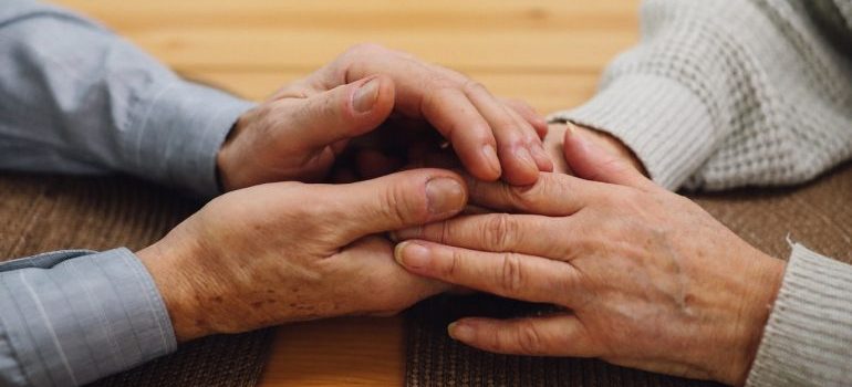 An elderly couple holding hands while exploring the top neighborhoods in Denver for seniors