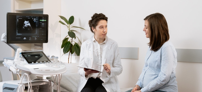 Two women discussing household costs and health insurance