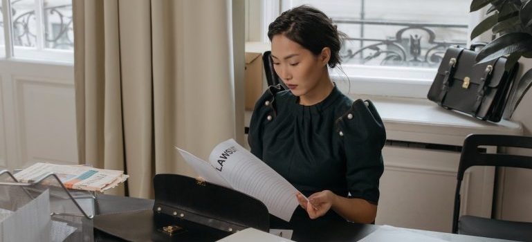 woman reading a document about the common mistakes when moving to Memphis