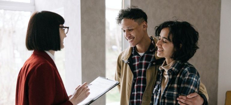A couple meeting with a real estate agent to discuss buying a home