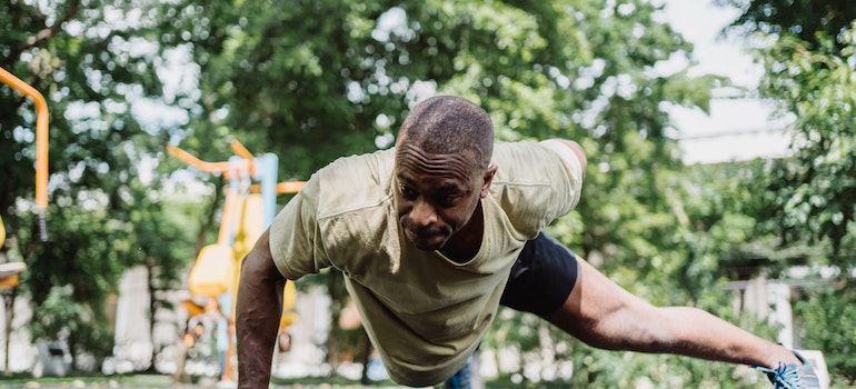 Man doing a stretching workout outdoors in a park