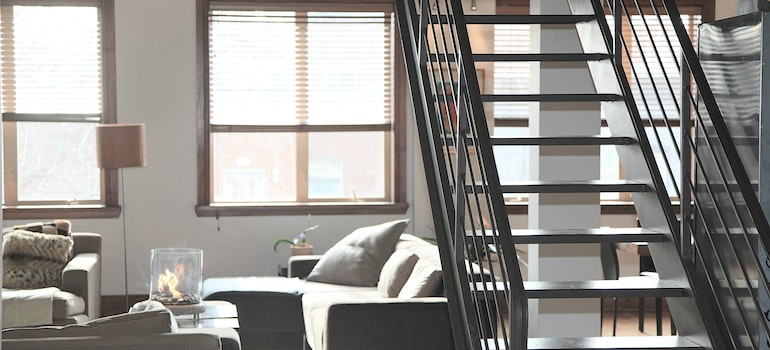 Bright apartment living room with a sofa and large windows, typical of the best Mississippi places for remote workers