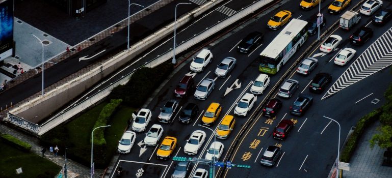 Cars driving on a multi-lane road in traffic