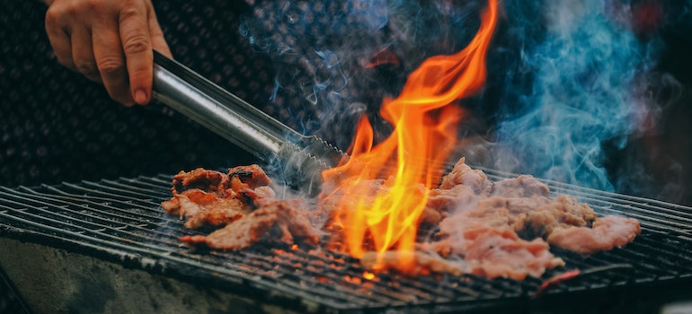 Meat and vegetables cooking on an outdoor grill