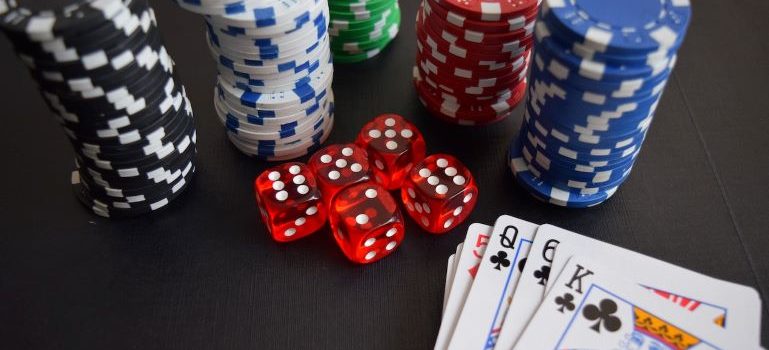 Playing cards, poker chips and dice on the table in a casino