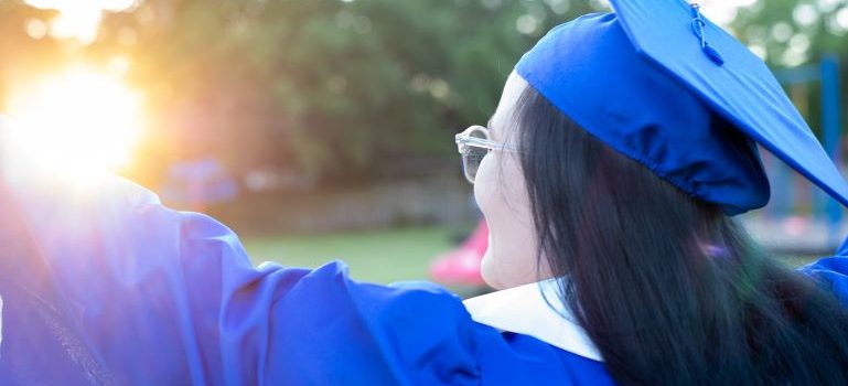 A woman in academic blue dress