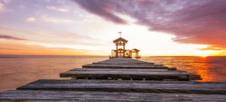 Lighthouse at the end of a road by the water