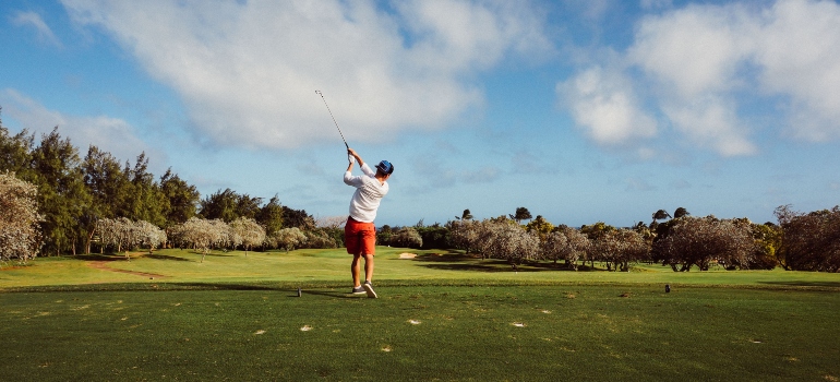 Man with a golf club on a golf course