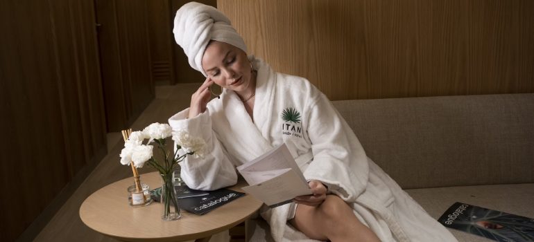 Woman reading a spa brochure in a calm treatment room