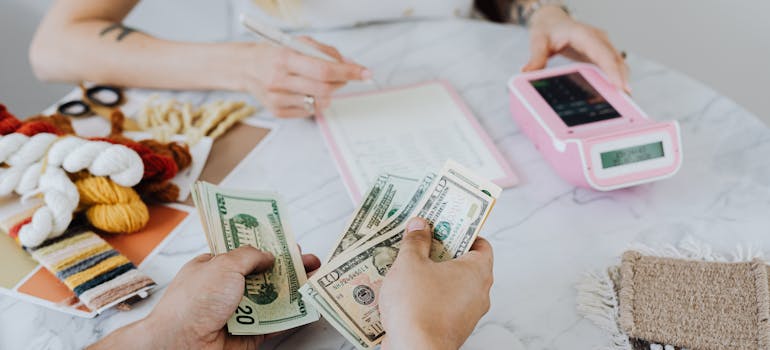 Person going over a household budget with a calculator and receipts