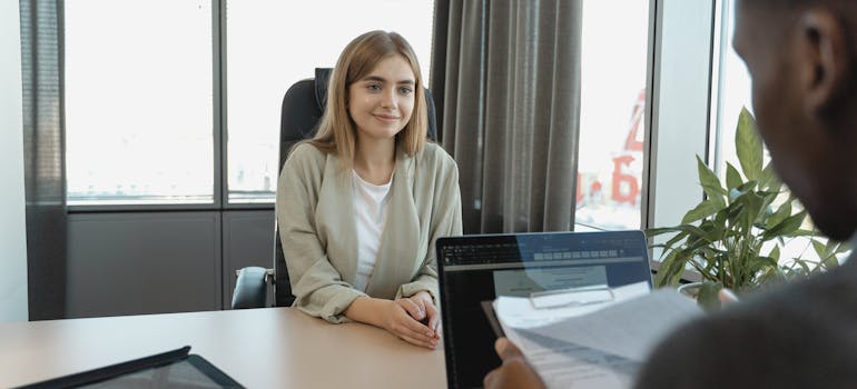 Young woman in a job interview across the desk from a hiring manager