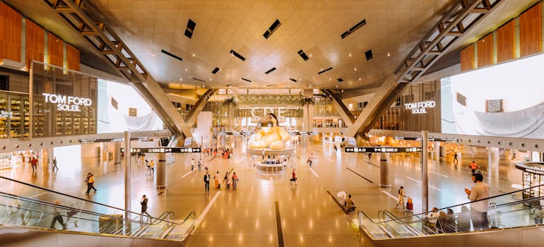 Shoppers walking through the interior of a large indoor mall