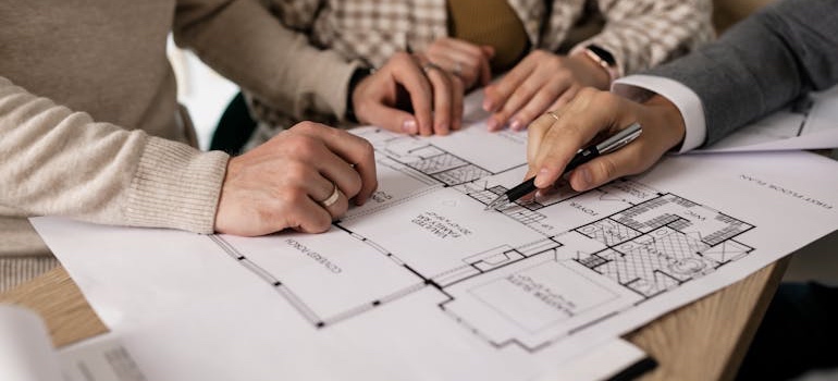 A person at a desk writing out a Denver home renovation plan