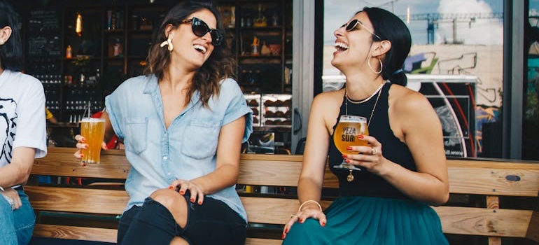 Friends talking and having drinks at a bar counter