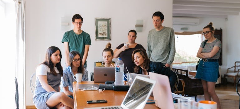 Coworkers at desks in a bright open-plan office