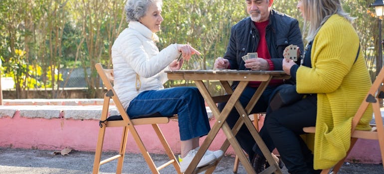 Seniors playing cards in a Memphis park, a good place to relax