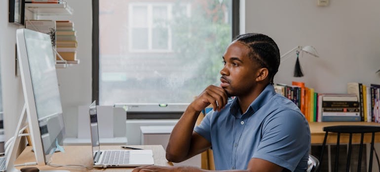 A man using his computer at home after moving